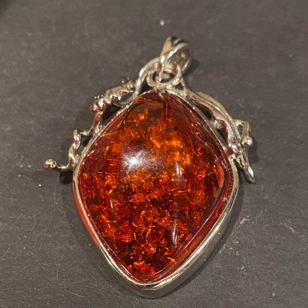 Silver Tone Pendant with Amber Tone     Does    not Glow.